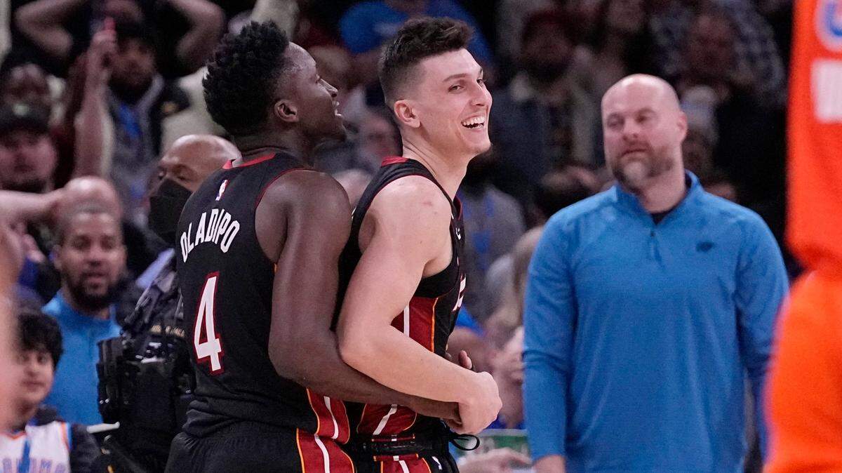 Miami Heat guard Tyler Herro, right, celebrates with teammate, Victor Oladipo, left, after the Miami Heat defeated the Oklahoma City Thunder in an NBA basketball game Wednesday, Dec. 14, 2022, in Oklahoma City.