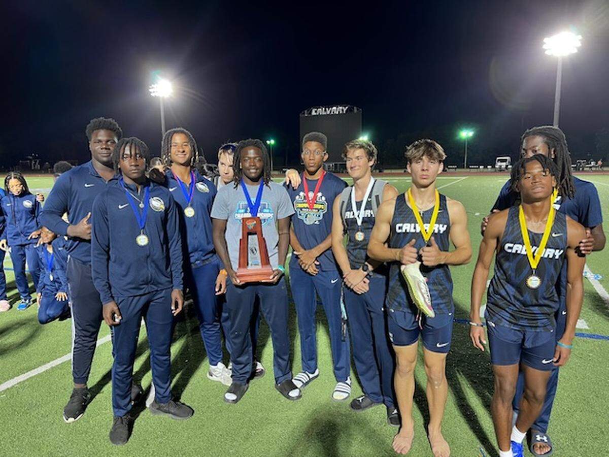 Calvary Christian’s boys’ track and field team celebrates after winning the Region 4-2A track and field championship at their home track.