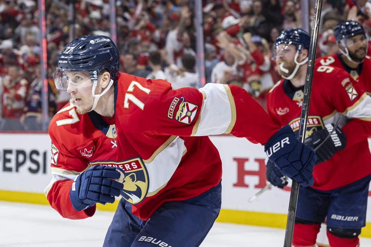 Florida Panthers defenseman Niko Mikkola (77) celebrates with his teammates after scoring against Carolina Hurricanes goaltender Pyotr Kochetkov (52) in the third period of Game 3 during the Eastern Conference final of the NHL Stanley Cup playoffs at Amerant Bank Arena on Saturday, May 24, 2025, in Sunrise, Fla.