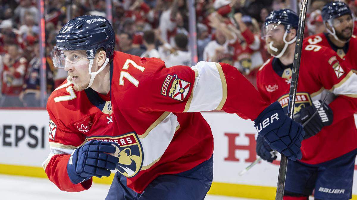 Florida Panthers defenseman Niko Mikkola (77) celebrates with his teammates after scoring against Carolina Hurricanes goaltender Pyotr Kochetkov (52) in the third period of Game 3 during the Eastern Conference final of the NHL Stanley Cup playoffs at Amerant Bank Arena on Saturday, May 24, 2025, in Sunrise, Fla.
