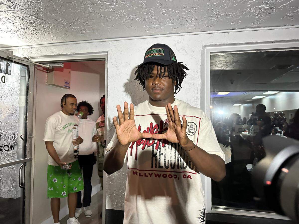 Miami Central five-star defensive lineman Armondo Blount gestures after announcing he signed with the University of Miami at a ceremony on Wednesday night at the Diversity Performing Arts Center in Lauderhill, Fla.