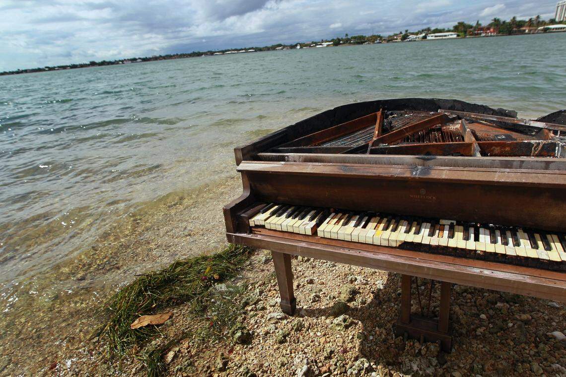 A grand piano is seen on a sandbar in Biscayne Bay on January 26, 2011 in Miami, Florida. The piano was charred from being burned.