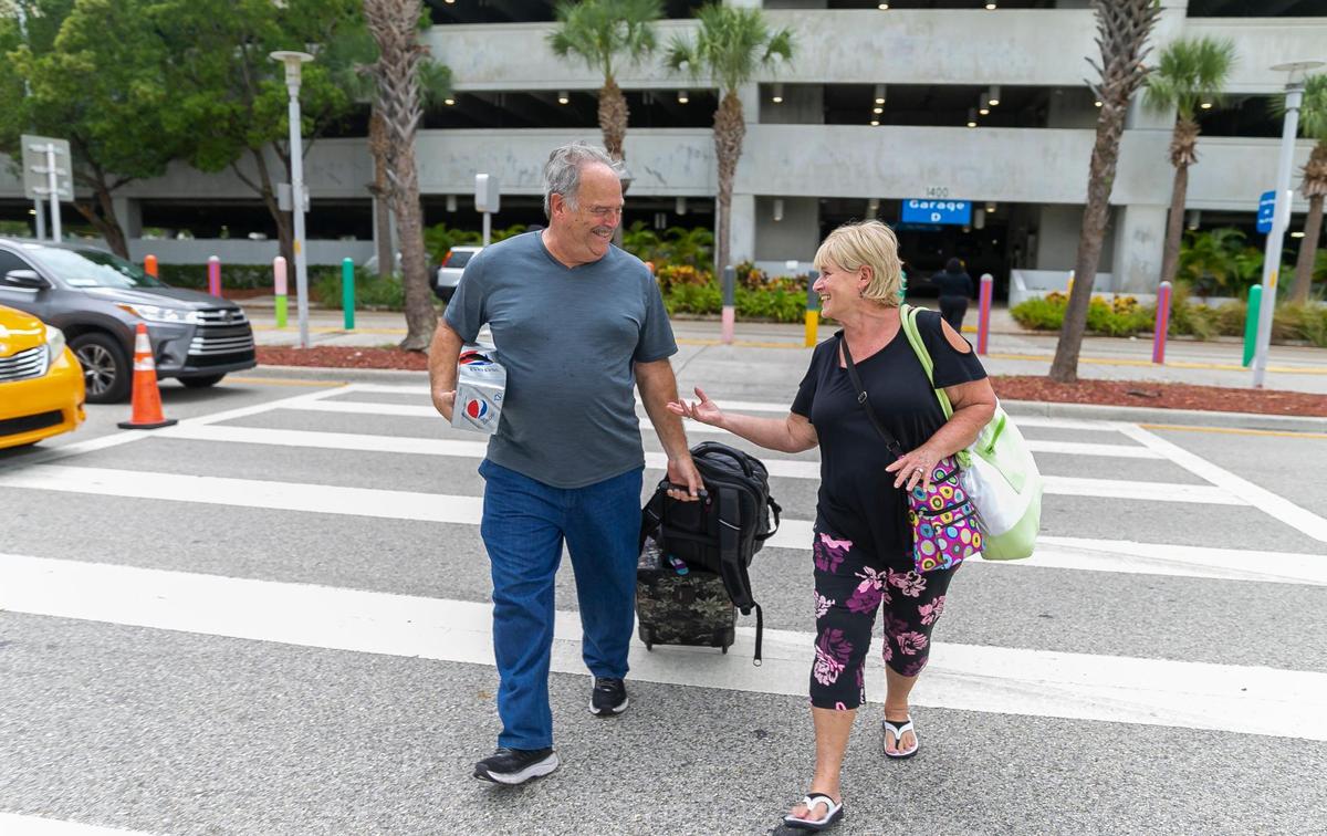 Nancy Houchens and her husband, Robert Houchens, make their way to board Carnival Conquest at PortMiami on Monday, Aug. 29, 2022, in Miami.