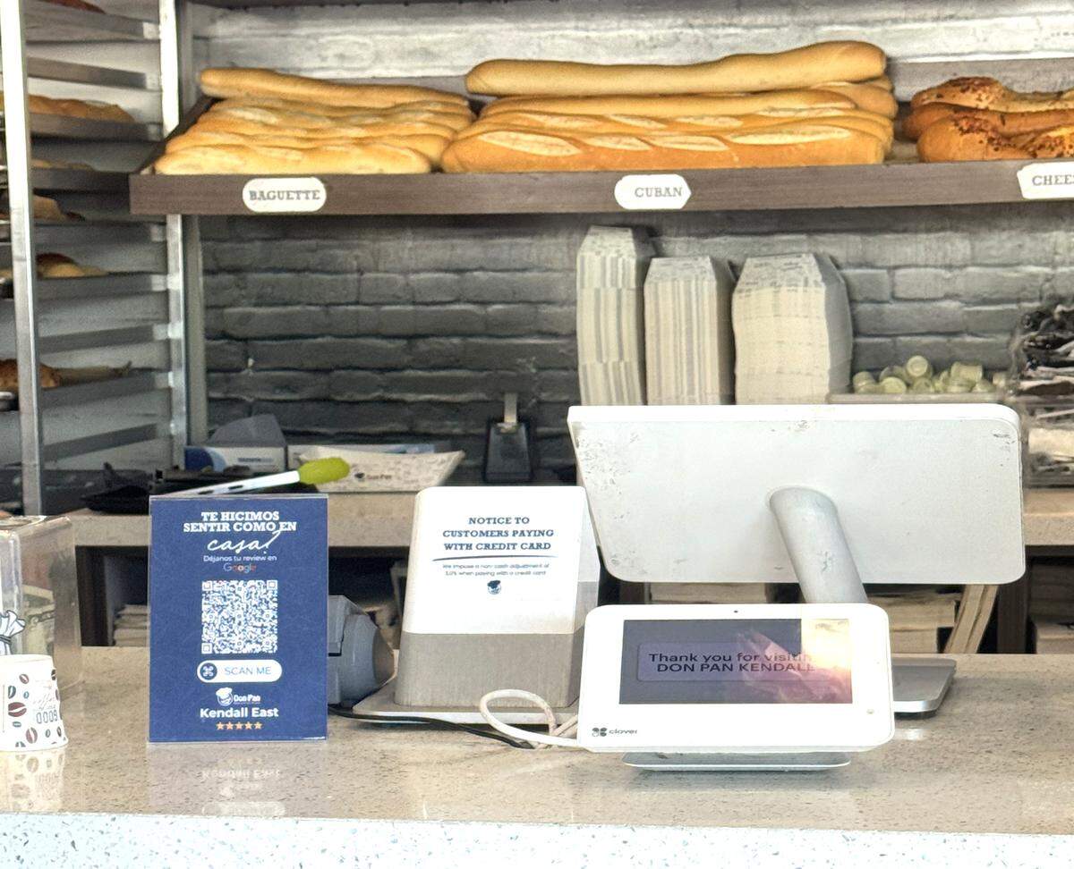 At Don Pan in Kendall, customers are warned about the credit card fee at the register before they order.