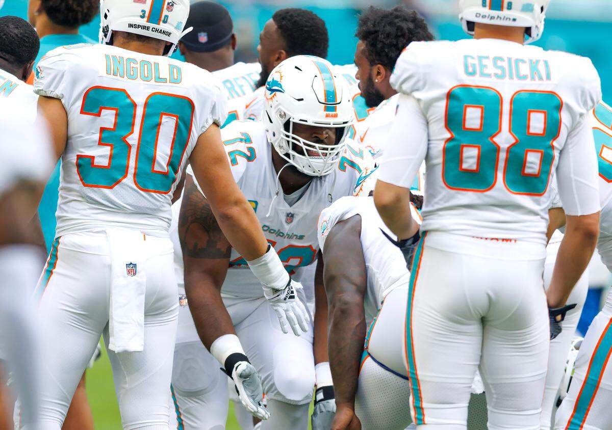 Miami Dolphins offensive tackle Terron Armstead (72) high five teammates before the start of an NFL football game against the Houston Texans at Hard Rock Stadium on Sunday, November 27, 2022 in Miami Gardens, Florida.