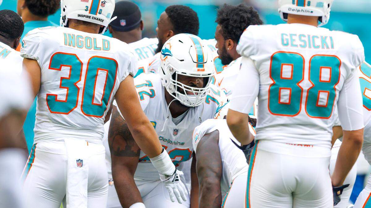 Miami Dolphins offensive tackle Terron Armstead (72) high five teammates before the start of an NFL football game against the Houston Texans at Hard Rock Stadium on Sunday, November 27, 2022 in Miami Gardens, Florida.