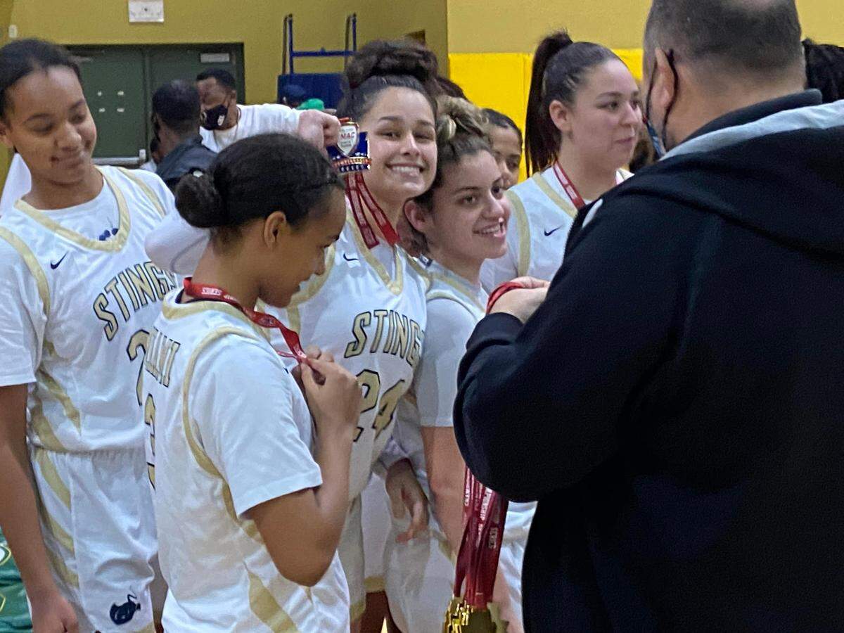 Miami High guard Cameron Araujo celebrates with her teammates after winning the GMAC girls’ basketball championship.
