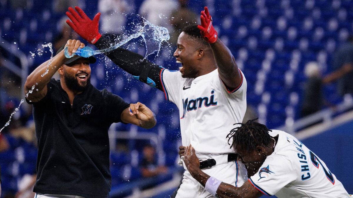 Miami Marlins Sandy Alcántara pours Gatorade on outfielder Jesús Sánchez (12) while Jazz Chisholm Jr. (2) hugs him after his walk-ooff single to win the game against Colorado Rockies during the tenth inning on Thursday, May 2, 2024, at loanDepot Park in Miami, Fla.