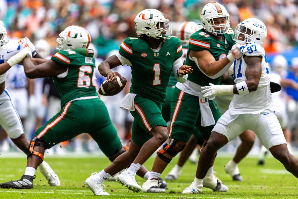 Miami Hurricanes quarterback Cam Ward (1) scrambles as he looks to throw during the first half of an ACC football game against the Duke Blue Devils at Hard Rock Stadium on Saturday, Nov. 2, 2024, in Miami Gardens, Fla.