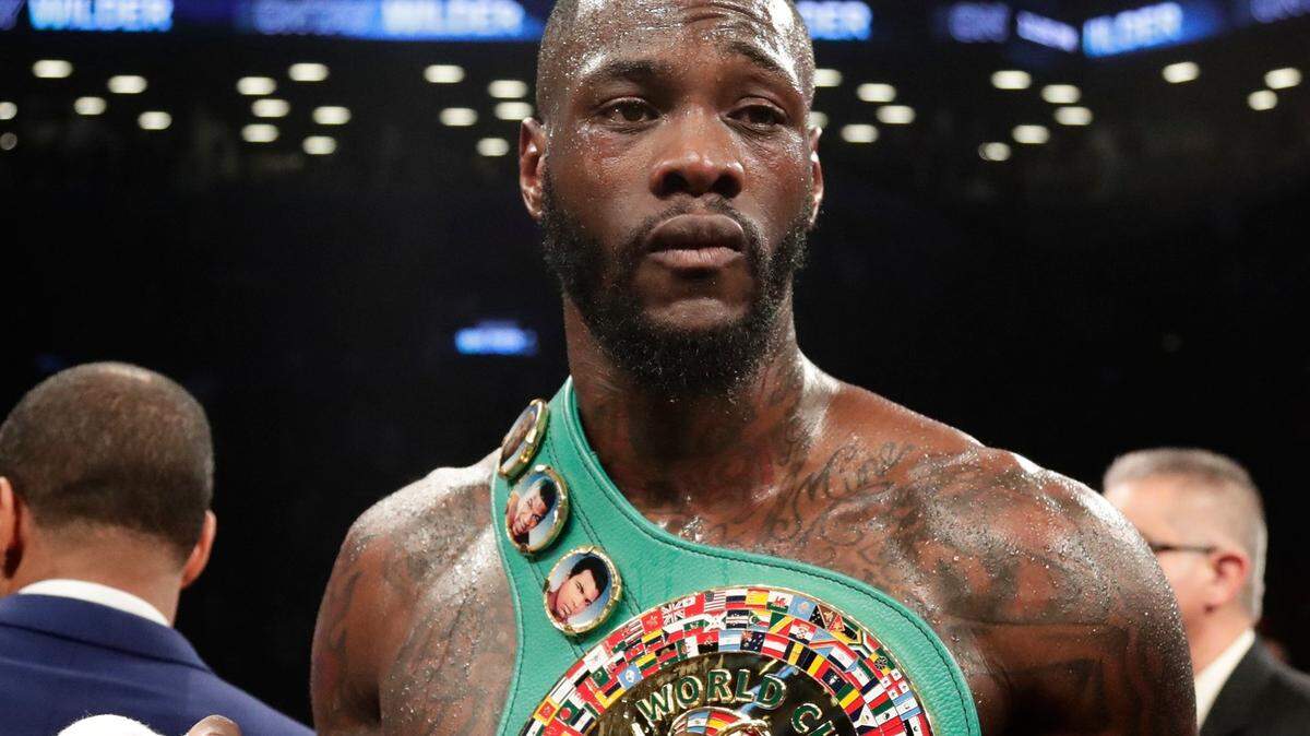 Deontay Wilder poses for photographs after the WBC heavyweight champion defeated Luis Ortiz in New York on March 3, 2018.