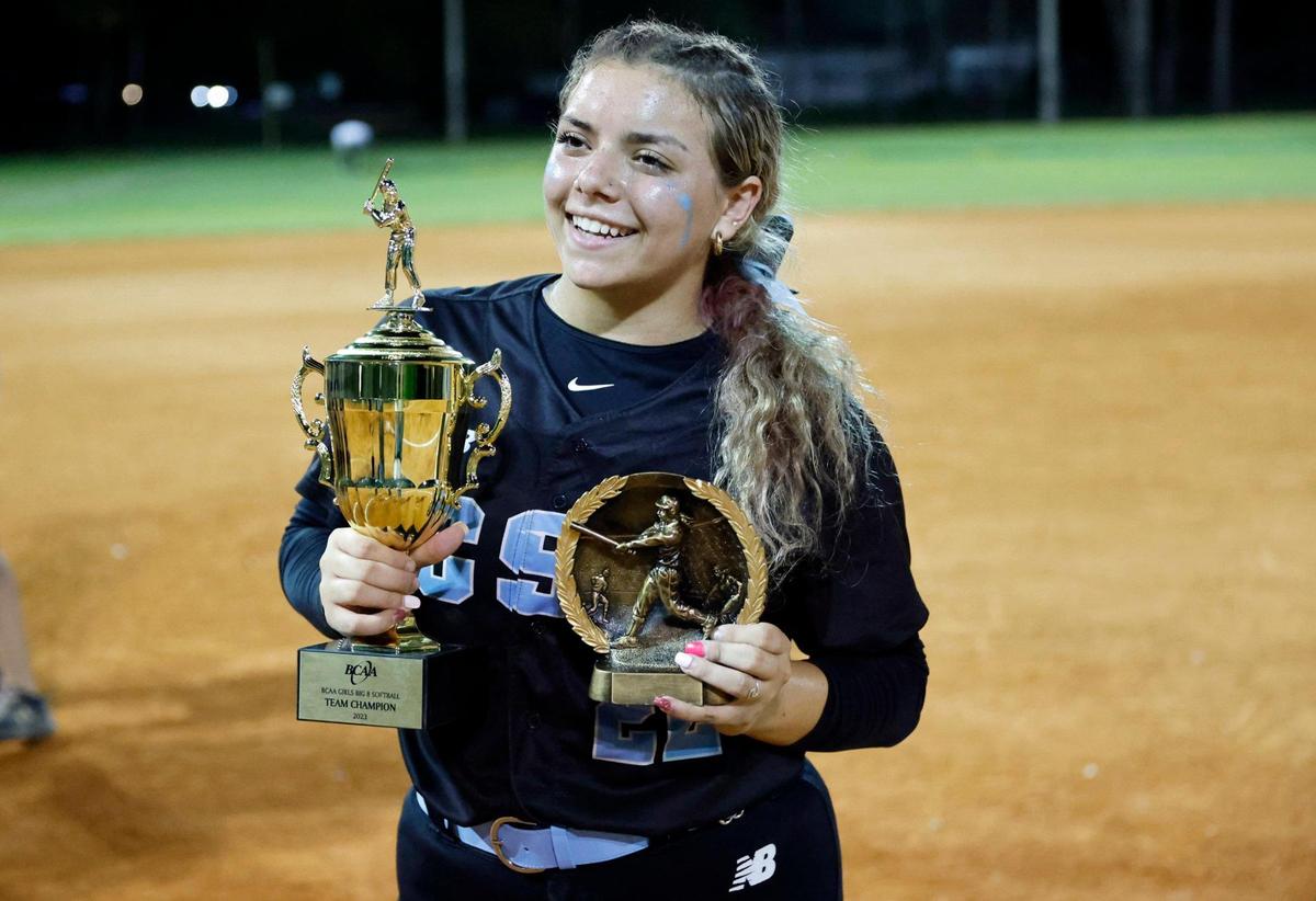 Stephanie Basso holds the championship and MVP trophies after the Coral Springs Charter softball team defeated Western in the BCAA Big 8 softball championship game at Pompano Beach Community Park in Pompano Beach on Thursday, April 27, 2023.