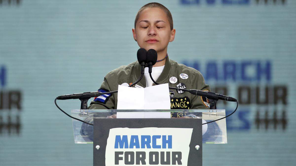 Emma Gonzalez, a survivor of the mass shooting at Marjory Stoneman Douglas High School in Parkland, Fla., closes her eyes and cries as she stands silently at the podium for the amount of time it took the Parkland shooter to go on his killing spree during the "March for Our Lives" rally in support of gun control in Washington on Saturday, March 24, 2018.