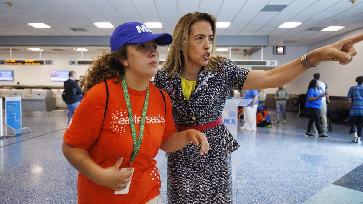 Commissioner Raquel Regalado, right, talks to her daughter, Isabela, during an airport readiness drill for children with autism organized by Easterseals South Florida to prepare them for experiencing air travel in 2024, at Miami International Airport. 