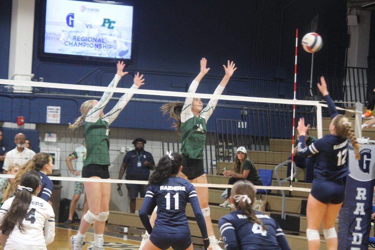 Gulliver’s Bennett Wolf (12) launches a shot past Pine Crest players during the Region 4-4A final match on Tuesday at the Raiders’ home gym.