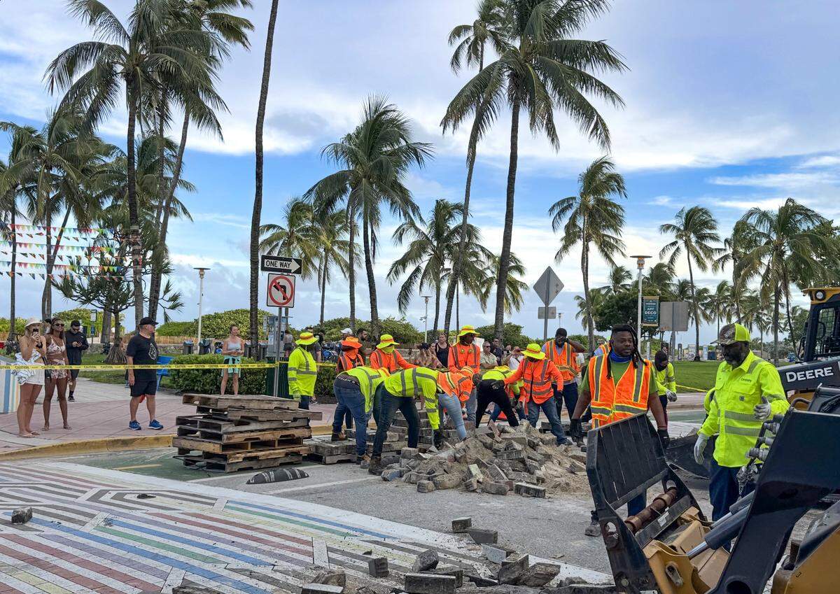 Workers remove part of the rainbow crosswalk intersection of Ocean Drive and 12th Street in Miami Beach on Sunday, Oct. 5, 2025.