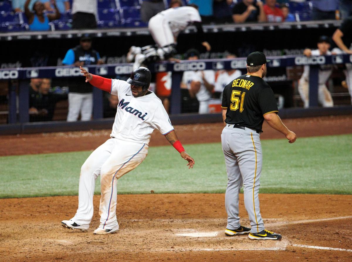 Miami Marlins first baseman Jesus Aguilar (99) scores on a wild pitch for a walk-off 5-4 win over the Pirates during the tenth inning of a baseball game at LoanDepot Park on Wednesday, July 13, 2022 in Miami, Florida.