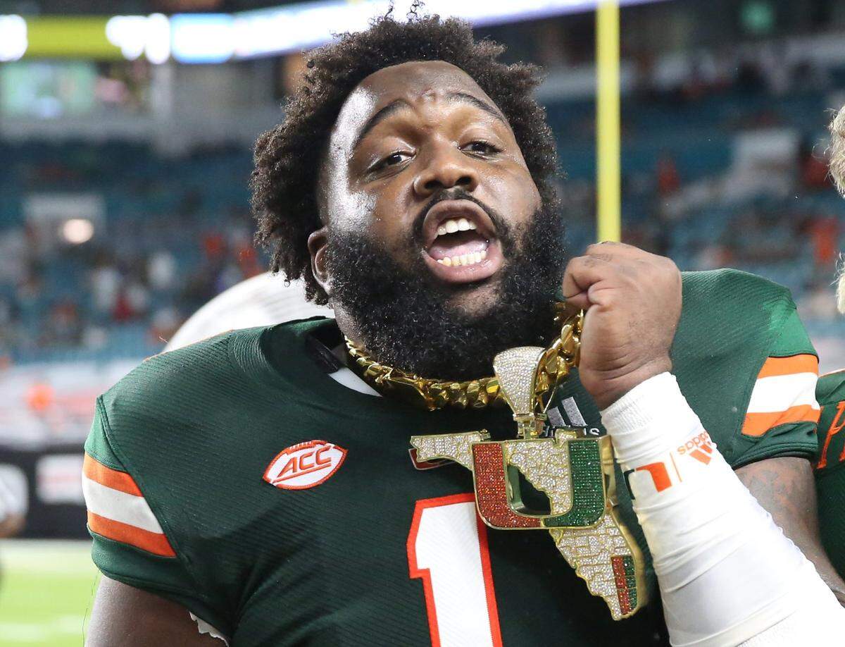 Miami Hurricanes defensive lineman Nesta Jade Silvera (1) celebrates with the turnover chain in the second quarter as the University of Miami hosts Florida State University Seminoles at Hard Rock Stadium in Miami Gardens on Saturday, September 26, 2020.