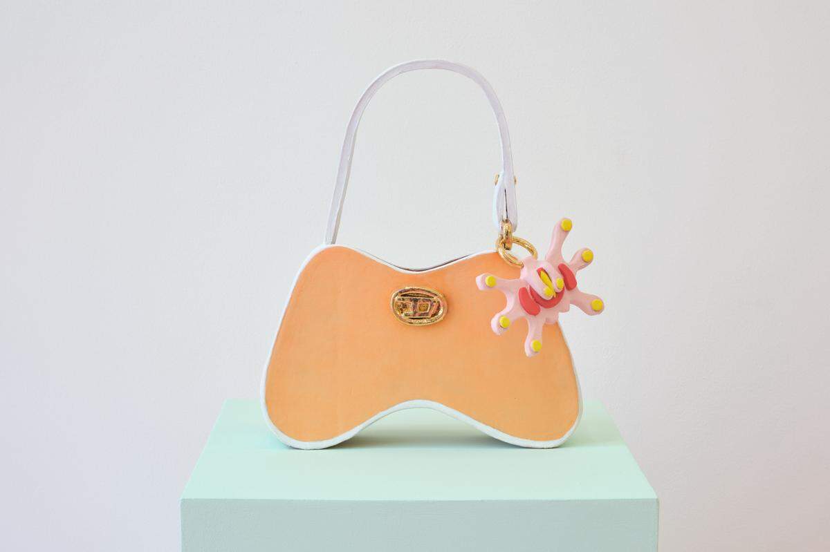 Artist Joel Gaitan made a ceramic recreation of his friend’s Diesel purse for his solo show “En El Corazón Del Infierno, En Las Alturas Del Cielo” at KDR. The piece is called “Sacred Object Study 2: Essential Everyday Bag.”