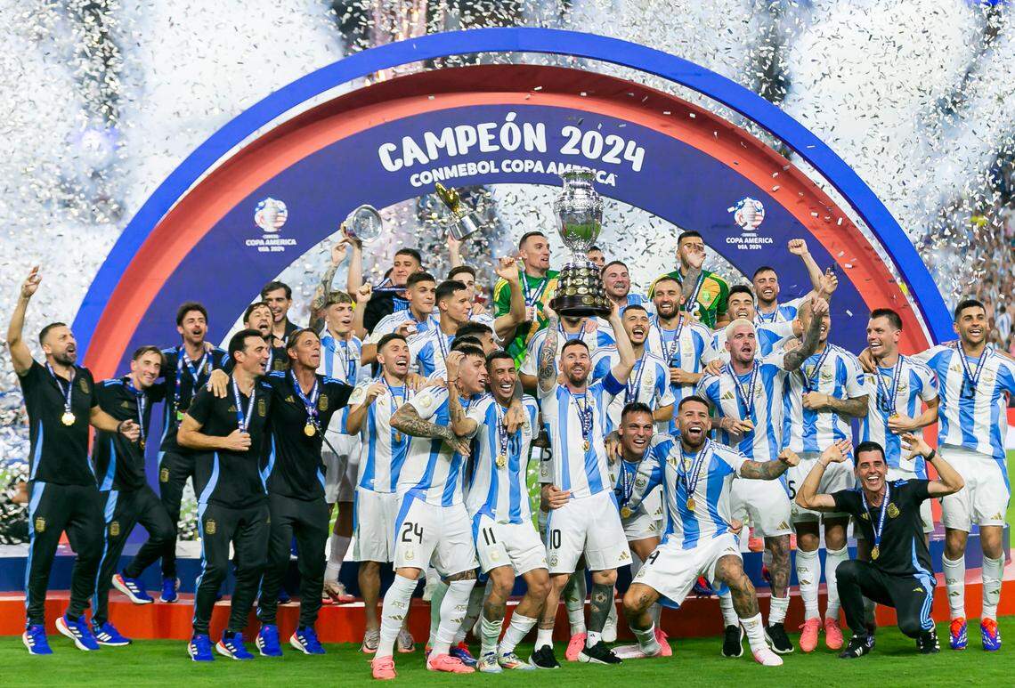 Argentina forward Lionel Messi (10) holds the trophy with his teammates after defeating Colombia in their Copa America 2024 Final soccer match at Hard Rock Stadium on Sunday, July 14, 2024, in Miami Gardens, Fla.