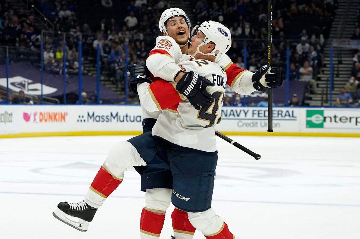 Florida Panthers defenseman Gustav Forsling (42) celebrates his goal against the Tampa Bay Lightning with defenseman Brandon Montour (62) during the third period in Game 3 of an NHL hockey Stanley Cup first-round playoff series Thursday, May 20, 2021, in Tampa, Fla. (AP Photo/Chris O’Meara)