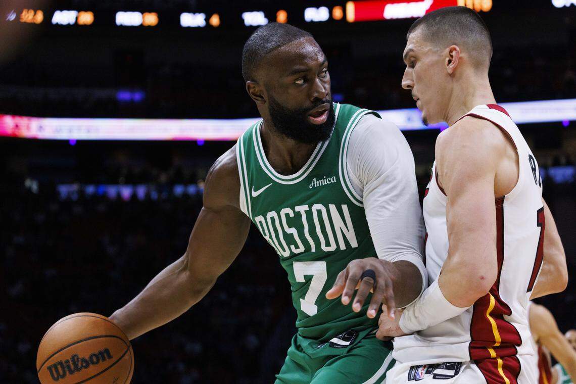 Boston Celtics guard Jaylen Brown (7) looks around Miami Heat guard Tyler Herro (14) during the second half of a game on Wednesday, April 1, 2026, at the Kaseya Center in downtown Miami, Fla.