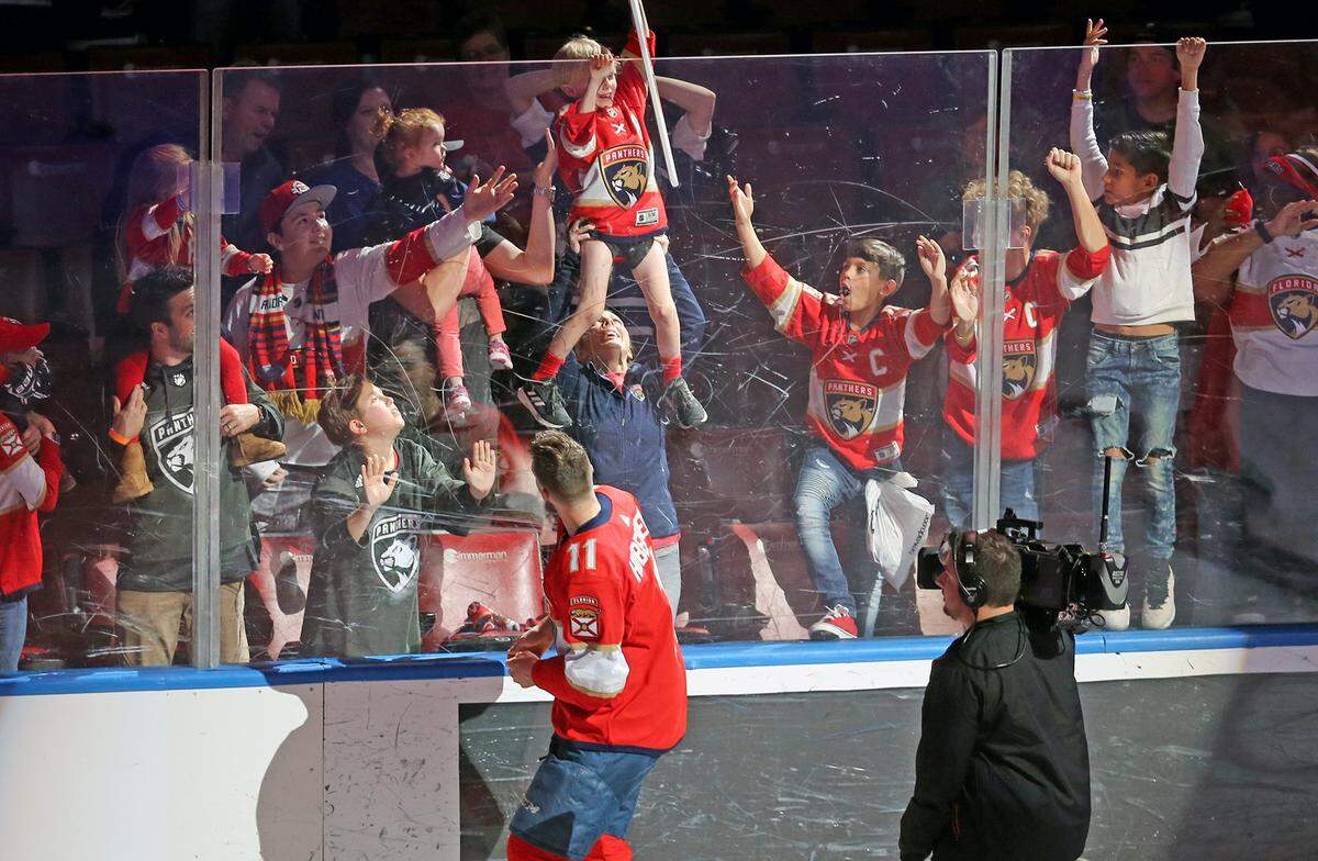 Florida Panthers Jonathan Huberdeau (11) gives his stick to a fan after being acknowledged as the Panthers all time high scorer after defeating the Toronto Maple Leafs 8-4 at the BB&T Center in Sunrise, Florida, Sunday, January, 12, 2020.