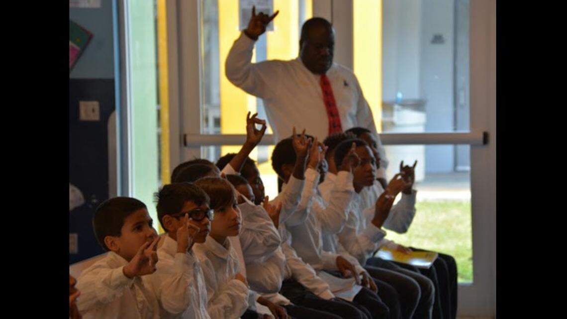 Holmes Elementary School math teacher Abe Coleman in class with the students he had mentored as part of his leadership role with the 5000 Role Models of Excellence Program at the Liberty City School.