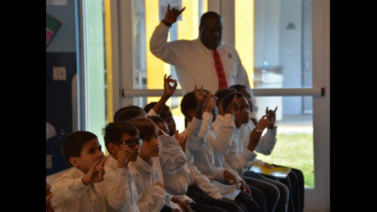Holmes Elementary School math teacher Abe Coleman in class with the students he had mentored as part of his leadership role with the 5000 Role Models of Excellence Program at the Liberty City School.