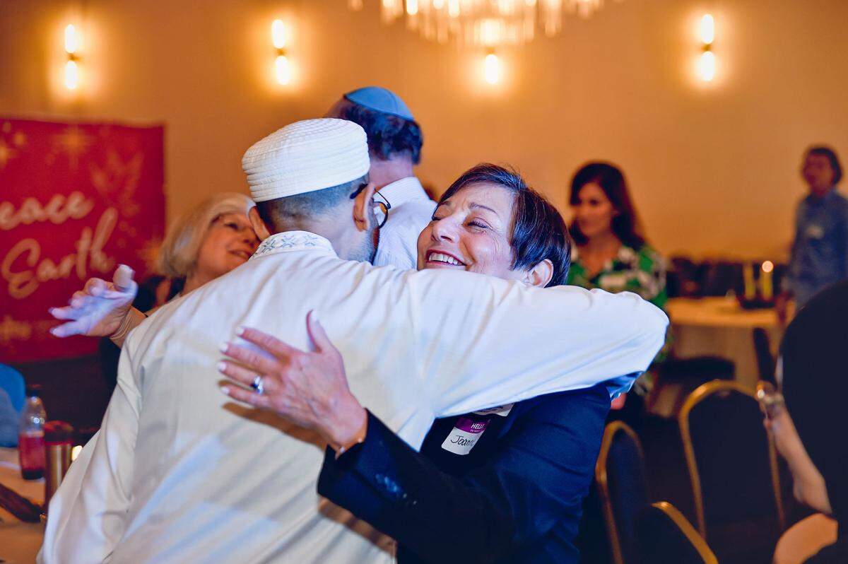 Dr. Iqbal Ahktar greets Joanne Harvest Koren, co-chair of the Unbiased Initiative at Temple Beth Am at an interfaith potluck at Unity on the Bay. The event brought together people of different religious backgrounds to talk, share a meal and build empathy for others.