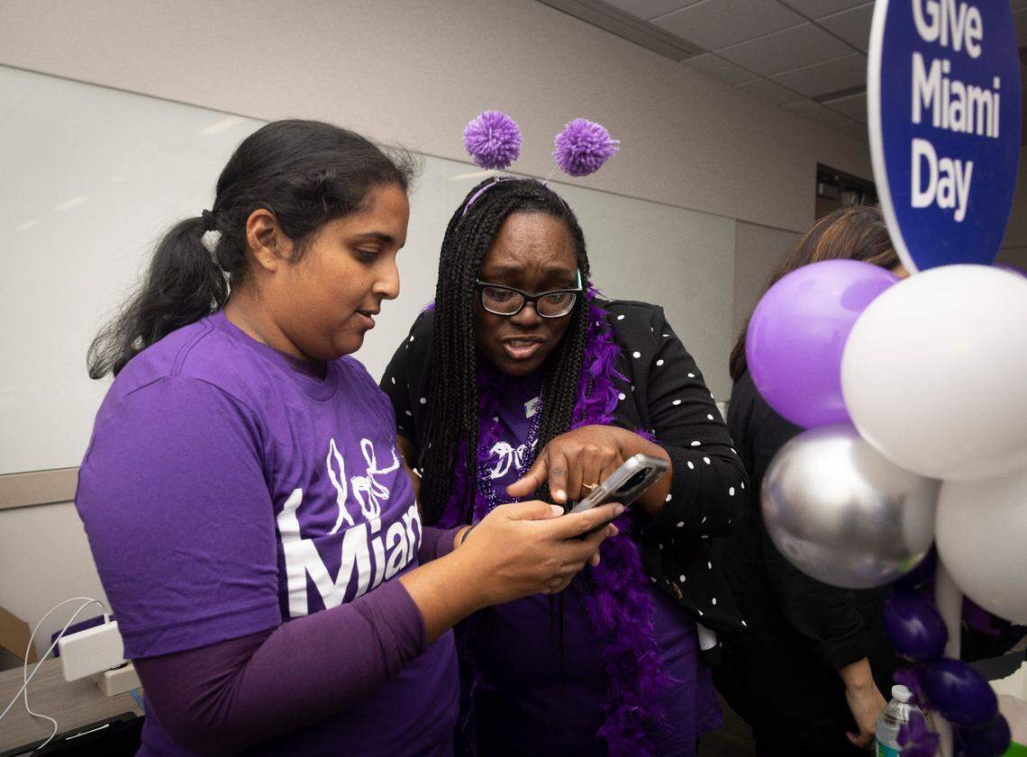Latasha Rhodes, right, from The Miami Foundation, talks to a volunteer during the Give Miami Day fundraising event hosted by The Miami Foundation on Thursday, Nov. 16, 2023, held at Miami Dade College Medical Campus.
