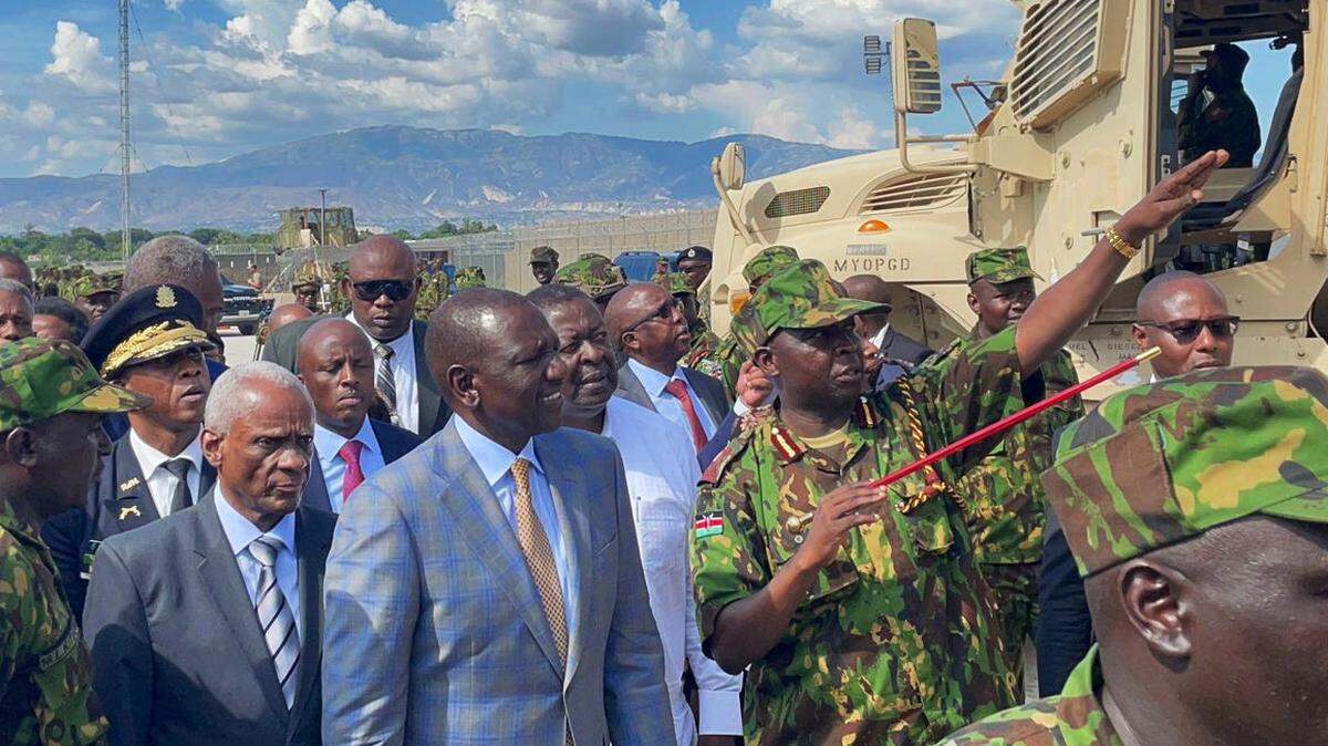 Kenya President William Ruto, center, wearing light gray jacket, talks to Godfrey Otunge, commander of the Kenya-led police force mission in Haiti, right, during a visit to Port-au-Prince, Haiti on Saturday, September 21, 2024 where nearly 400 members of his police force is leading the Multinational Security Support mission. Ruto, who had Edgard Leblanc Fils, president of the Transitional Presidential Council on his other side, was on his way to the United Nations General Assembly in New York.