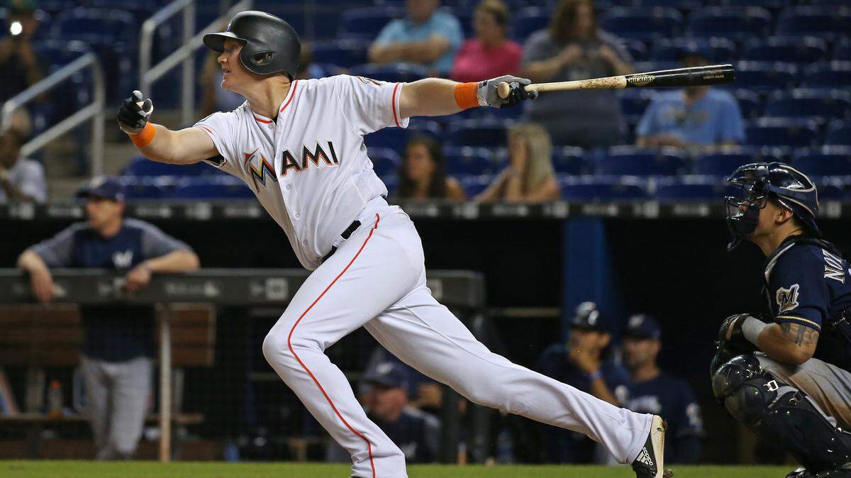 Miami Marlins left fielder Garrett Cooper hits a single during the twelfth inning of a Major League Baseball game against the Milwaukee Brewers at Marlins Park on Wednesday, July 11, 2018.