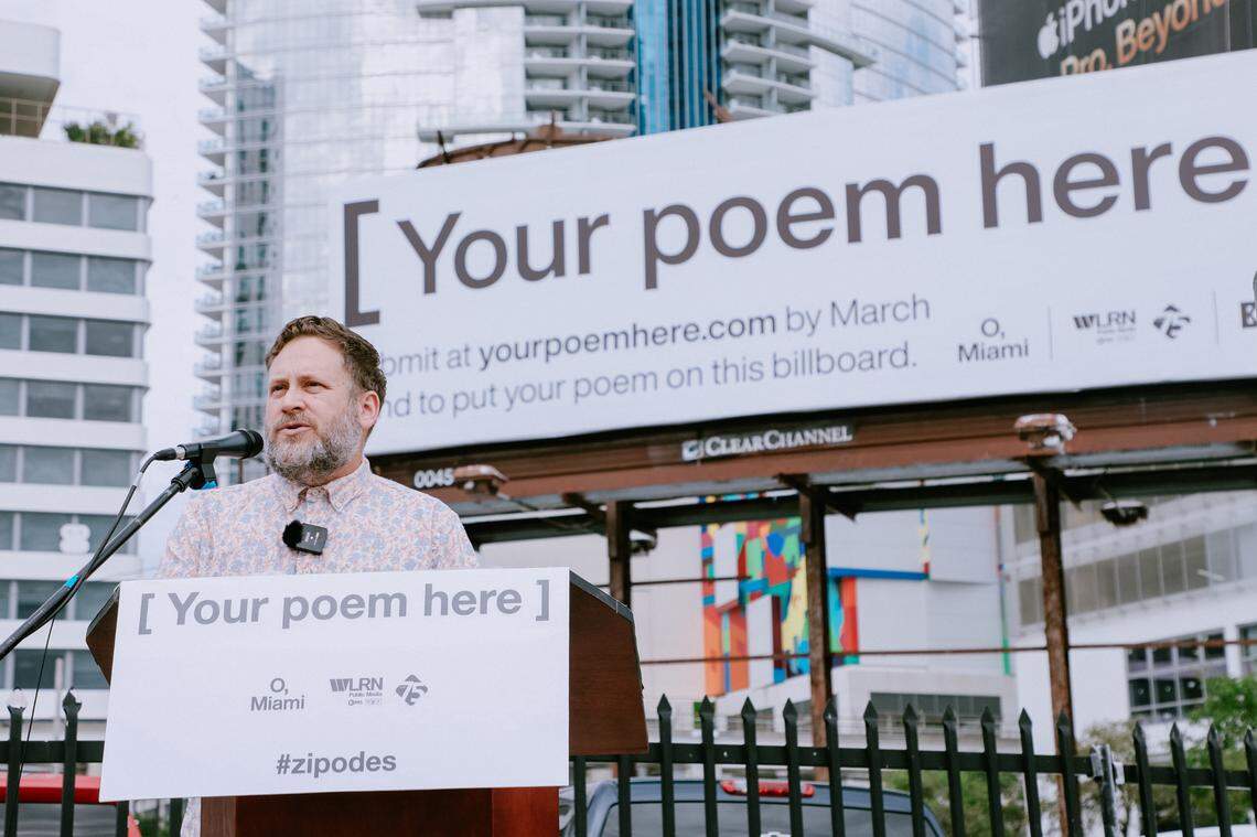 P. Scott Cunningham, the O, Miami founder and executive director, speaks in front of a billboard the organization purchased for its poetry contest.