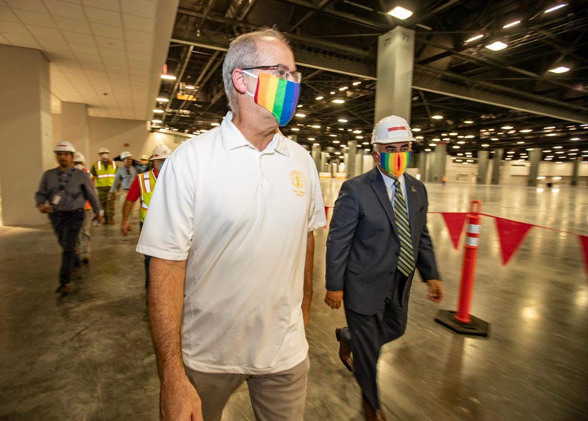 Miami Beach Mayor Dan Gelber, left, and City Manager Jimmy Morales tour the Miami Beach Convention Center as the U.S. Army Corps of Engineers builds a coronavirus field hospital inside the facility on April 8, 2020.