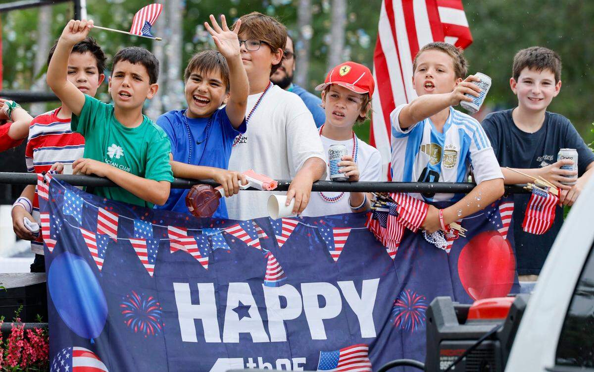Residents, family and friends celebrate Independence Day during the 66th Annual Key Biscayne Fourth of July Parade on Key Biscayne, Florida on Friday, July 4, 2025.