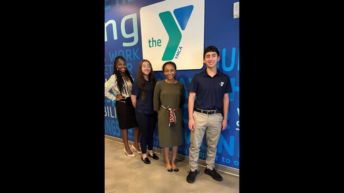 Kaydean Brown, associate executive director of Community Health Strategies for the YMCA of South Florida, celebrates with the 2022 Miami-Dade County Bank of America Student Leaders Jimena Somoano, Cori’Anna White and Shawn Martinez.