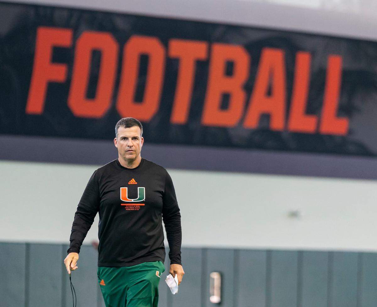Miami Hurricanes head coach Mario Cristobal makes his way toward a press conference after running drills at the University of Miamis Greentree Practice Fields on Monday, Aug. 15, 2022, in Coral Gables, Fla.