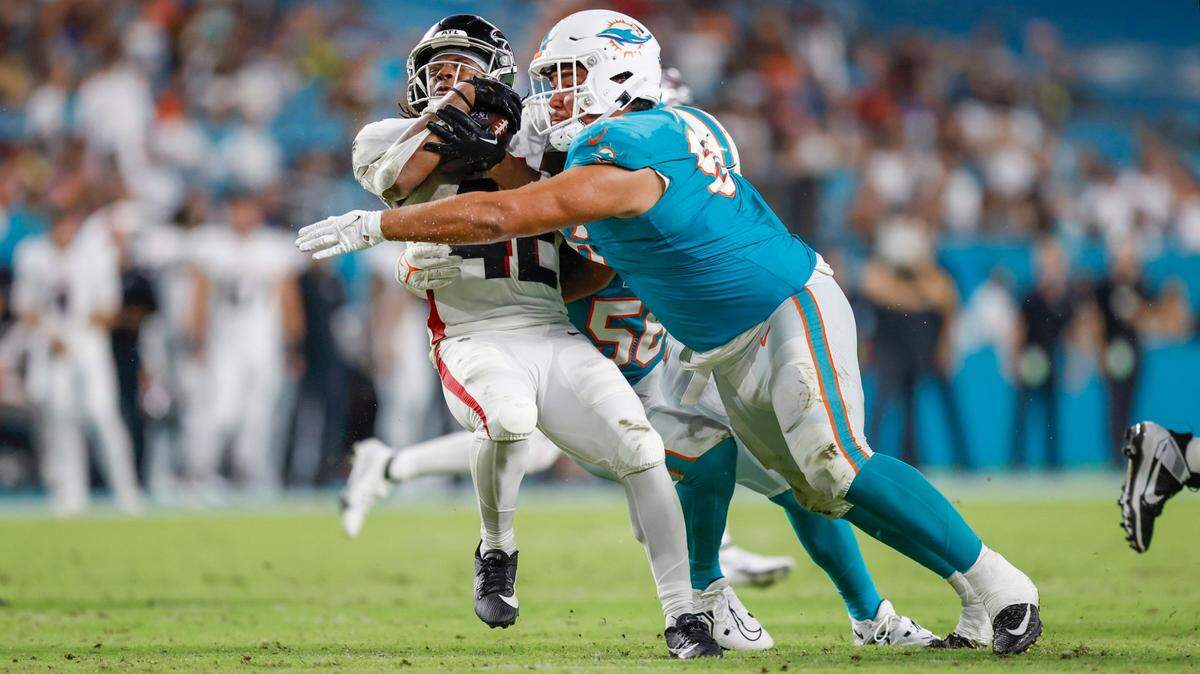 Miami Dolphins defensive tackle Brandon Pili (96) tackles Atlanta Falcons running back Godwin Igwebuike (42) in the fourth quarter during the only preseason game at Hard Rock Stadium on Friday, August 11, 2023.
