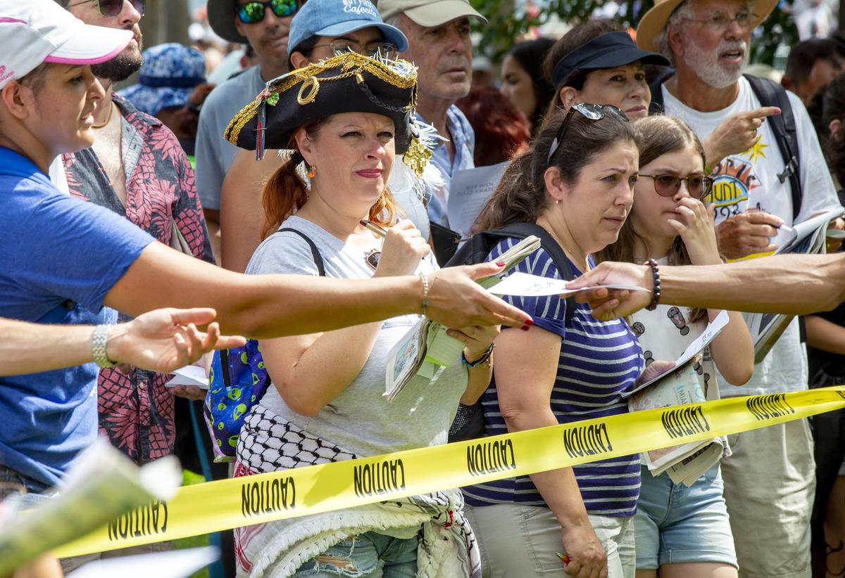 Sporting a pirate hat, Adrienne Denaro, 41, gazes at one of the clues in the 2019 Herald Hunt. Denaro has participated in every Herald Hunt, starting when she was only 6 years old.