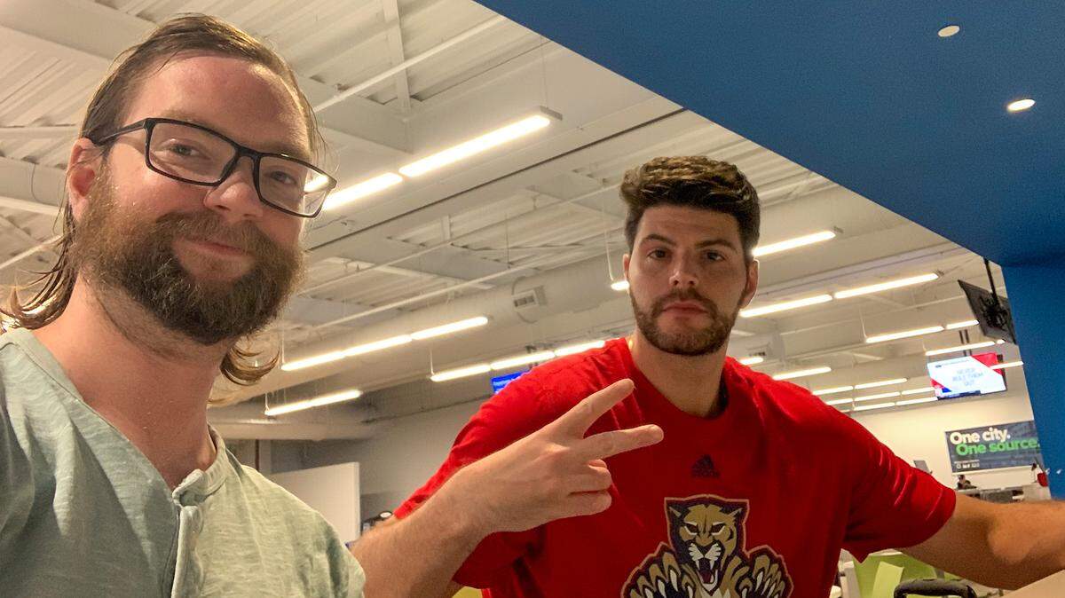 Miami Herald sports writer Jordan McPherson and Florida Panthers fan Jake Levine wait for their flight at the Region of Waterloo International Airport to get to Edmonton for Game 6 of the Stanley Cup Final after their initial connection from Toronto to Edmonton was canceled.