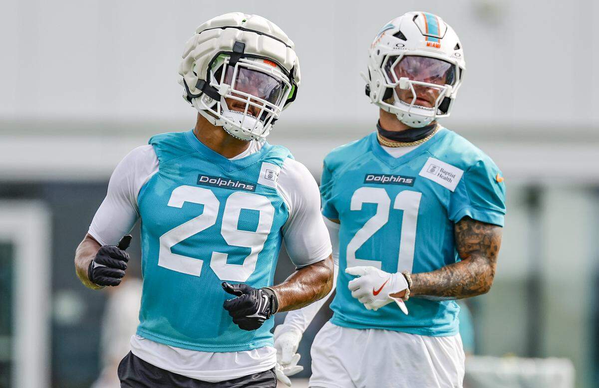 Miami Dolphins safety Minkah Fitzpatrick (29) and safety Ashtyn Davis (21) run through practice drills at the Miami Dolphins Training Camp in Miami Gardens, Florida, on Monday, July 28, 2025.