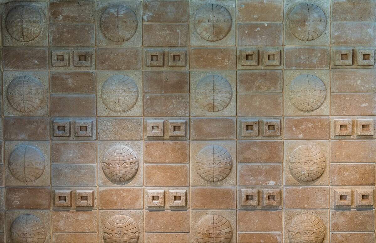 Detail of the original Pan Am logo on a tile wall at the PS MIA, a luxury private terminal at Miami International Airport that allows commercial flight passengers to bypass the main airport crowds. Located at the historic former Pan American Airways headquarters (4900 NW 36th St), offers private TSA screening, Customs clearance, chef-prepared meals, spa services, and airfield transfers in a BMW, on Friday June 12, 2026.