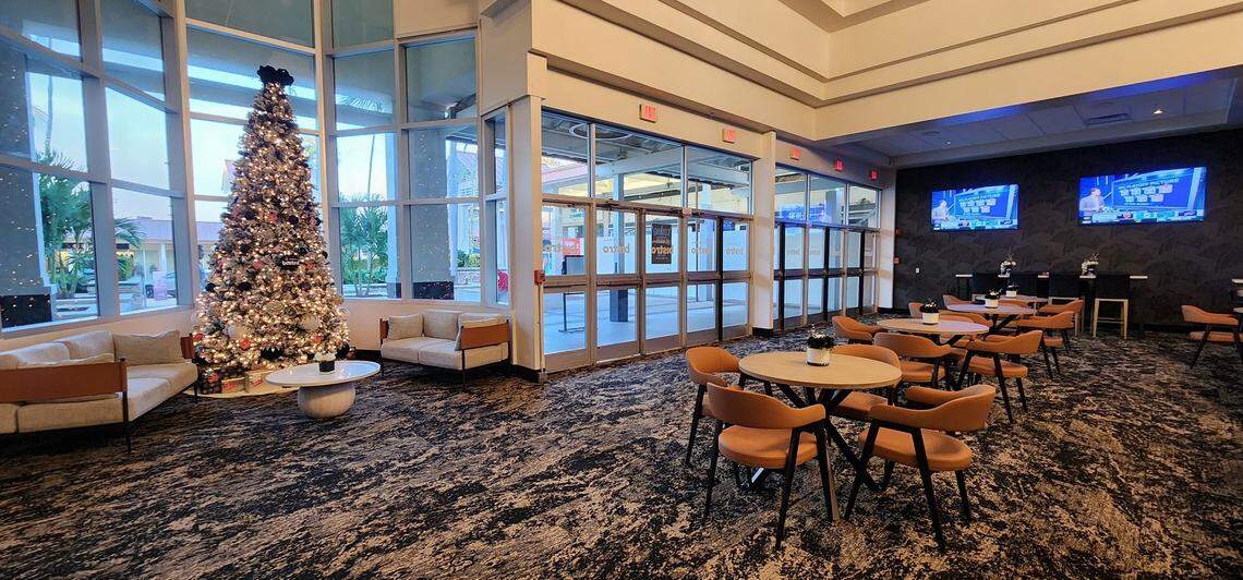 Another look at the modern lounge area at the new Regal Bistro movie theater at The Falls from the lobby looking out toward the mall. The lounge serves as a communal pre- and post-movie hub for guests to congregate, Regal said in a statement. The new bar offers a selection of 24 beers on tap, including a few local craft labels. The lounge is also surrounded by large-screen televisions tuned into current non-cinema entertainment. Regal announced the opening on Dec. 17, 2025.