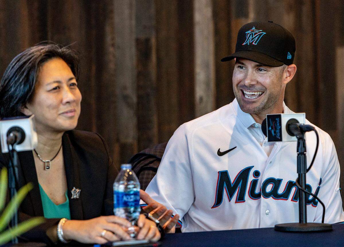 Skip Schumaker, right, speaks about Marlins general manager Kim Ng, left, during the press conference at LoanDepot Park officially announcing him as the Marlins’ new manager