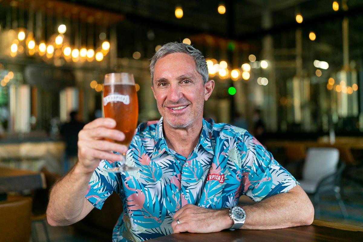 Manny Portuondo, the CEO of Cerveceria La Tropical, with an amber lager at his brewery and taproom.