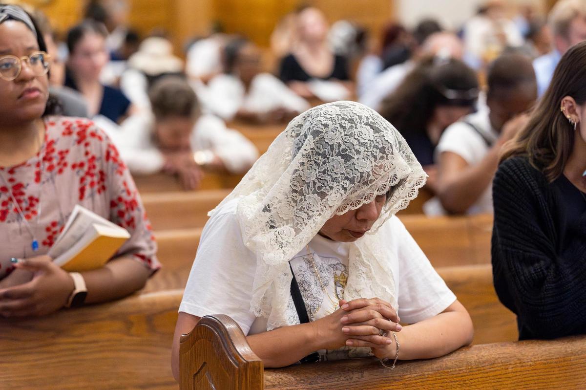 Gloria Sanchez, 58, prays during a Good Friday service at the Cathedral of St. Mary on Friday, April 18, 2025, in Miami, Fla.