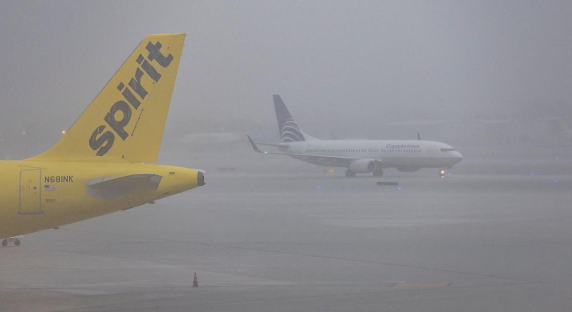 An airplane is seen on the runway as heavy rain falls over the Fort Lauderdale-Hollywood International Airport on Wednesday, June 12, 2024, in Fort Lauderdale, Fla. Many flights were either canceled or delayed due to the bad weather.