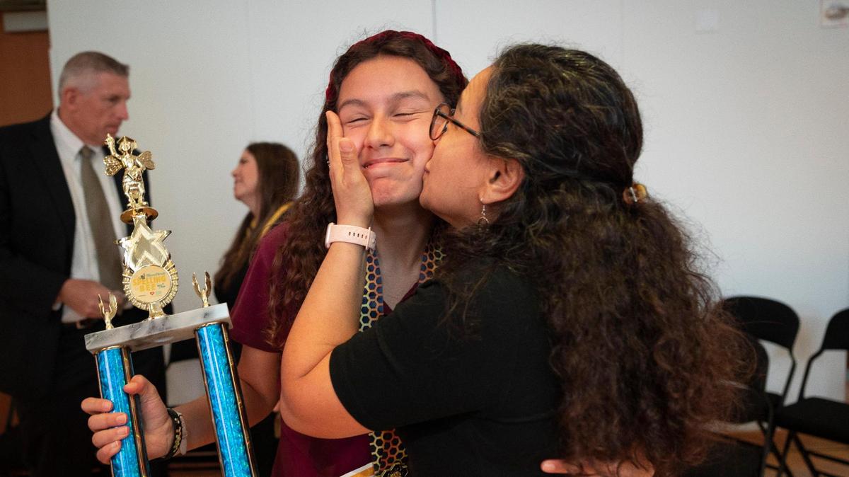 Camila Sanchez-Izquierdo, from Highpoint Academy, left, is embraced by her mother, Gianna, after winning the Miami Herald Miami-Dade/Monroe County Spelling Bee by spelling “panopticon” and “retrospect” on Wednesday, March 6, 2024, at the New World Center in Miami Beach.