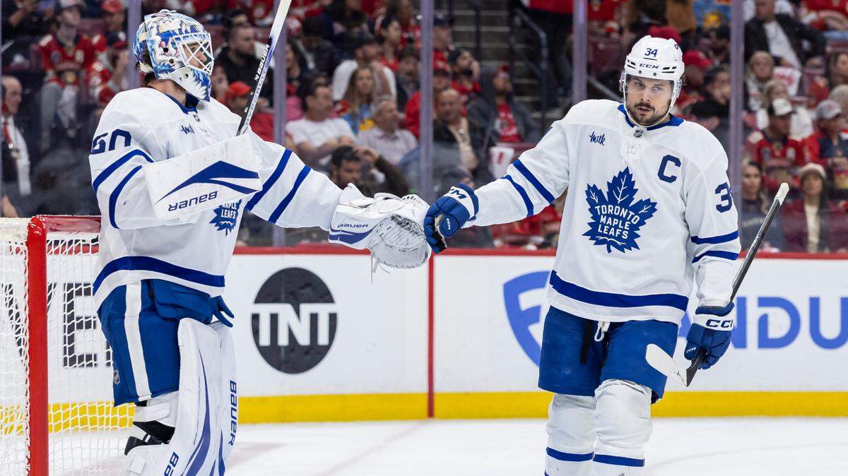 Toronto Maple Leafs center Auston Matthews (34) celebrates with goaltender Joseph Woll (60) after scoring against the Florida Panthers in the third period of Game 6 of a second-round Stanley Cup playoffs series at the Amerant Bank Arena on Friday, May 16, 2025, in Sunrise, Fla.