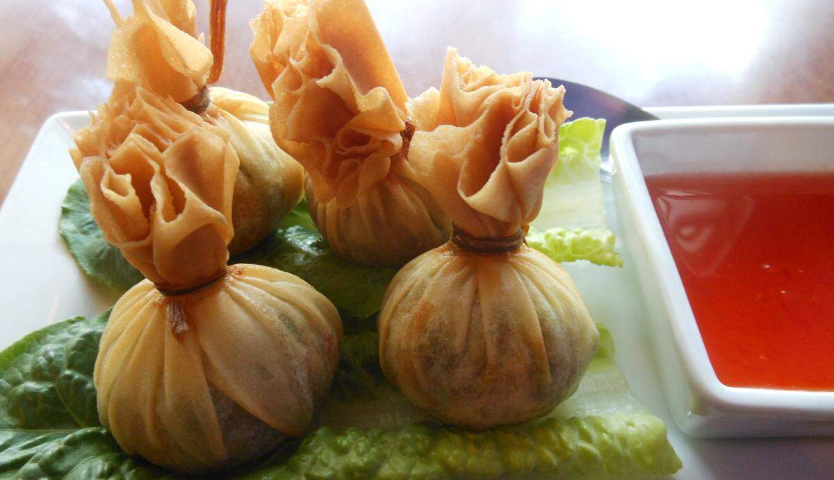 Malakor Thai Isaan’s Money Bags, eggroll skins stuffed with a mash of sweet potato and peas tied into a pouch